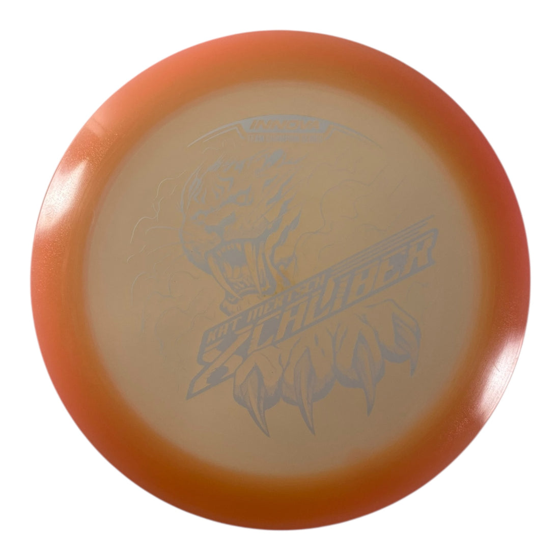Innova Champion Discs XCaliber | Champion Color Glow | Tan/White 175g (Kat Mertsch) Disc Golf